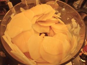 Sliced potatoes in the Cuisinart. You can also use a mandoline slicer to get uniform slices. 